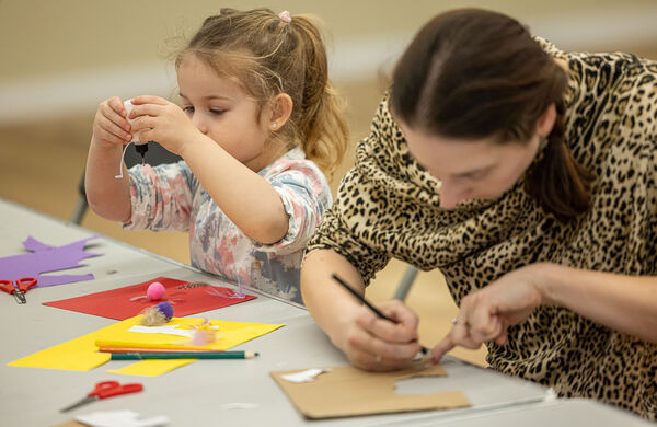Adult and young child drawing and crafting together
